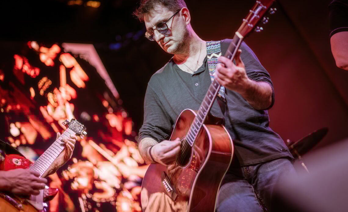 Band performs on stage, rock music concert.