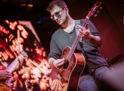 Band performs on stage, rock music concert.