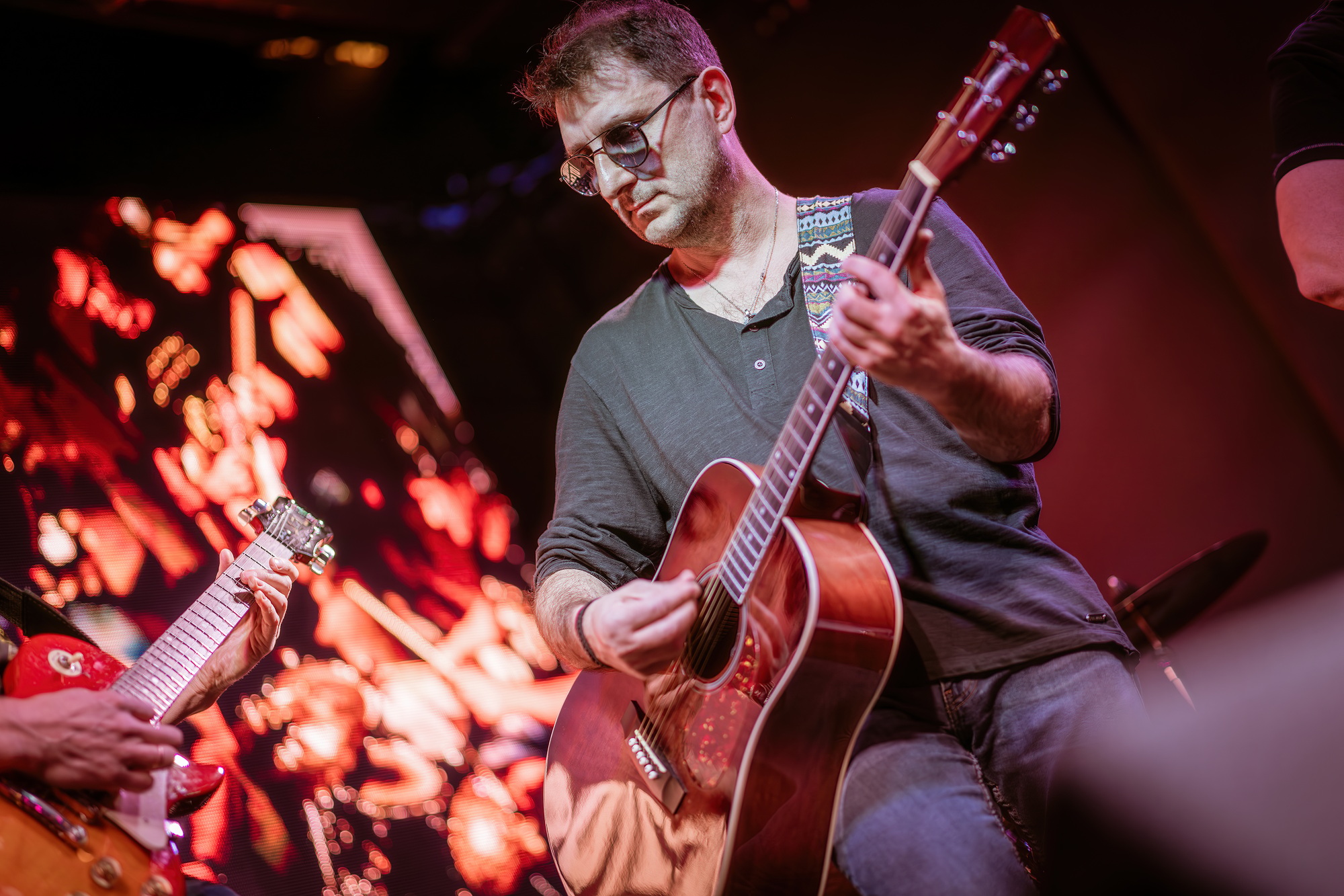 Band performs on stage, rock music concert.