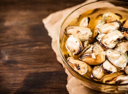 Pickled mussels in a glass bowl.